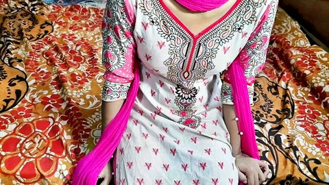 Sexy Indian teen in pink embroidered salwar kameez teasing cleavage on bed