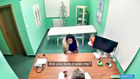 Brunette MILF kneels before older doctor at desk in exam room, fur coat open teasing tits and pussy