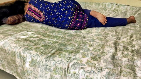 Indian housewife lying prone on bed with bare soles up teasing feet