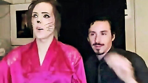 Kinky shemale in cat makeup and silky robe on live cam with male partner