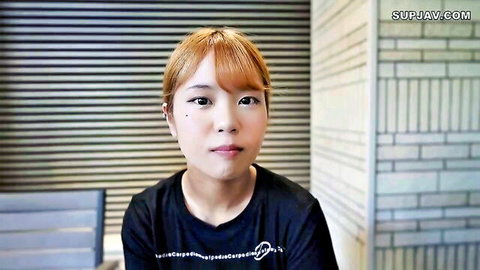 Cute Asian JAV babe with short red hair smiling in tight black top