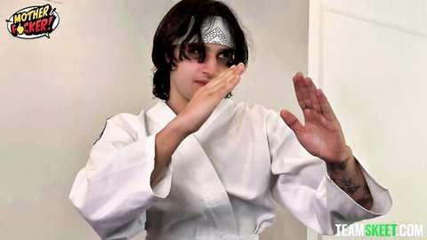 Young skinny Caucasian girl in white karate gi striking intense rough pose