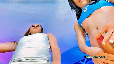 Brunette in blue bikini top fingers wet pussy over eager blonde babe lying below
