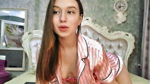 Cute brunette e-girl in open pink striped satin pajamas teasing deep cleavage solo on bed