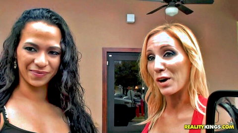 Busty brunette and blonde MILFs with huge tits teasing deep cleavage outdoors near car