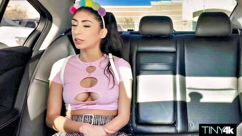 Brunette babe exposes huge tits through cutout pink top and sticks tongue out seductively in car backseat