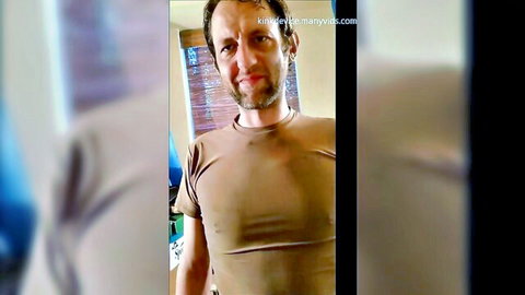 Bearded man in tight beige t-shirt posing solo with naughty smile