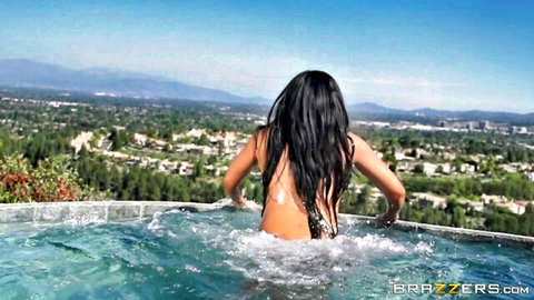 Rio Lee in skimpy bikini diving into pool from behind, scenic view