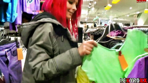 LexyRoxx tattooed redhead in hoodie browsing clothes in store
