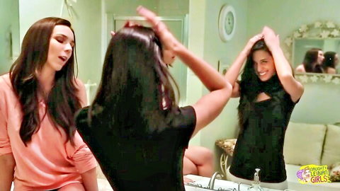 Tiffany Tyler in teasing bathroom pose with brunette friend, long hair styling