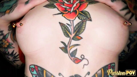 Tattooed babe's huge pierced tits with vibrant rose tattoo between them in POV