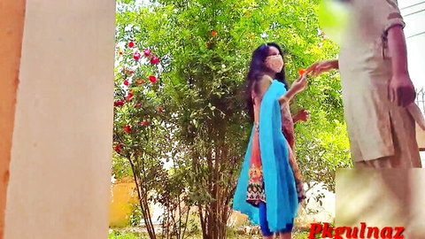 Desi sister-in-law in blue dupatta reaches for hand in park outdoor scene