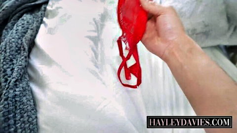 Hayley Davies teasing with red lace panties pulled aside, close-up view