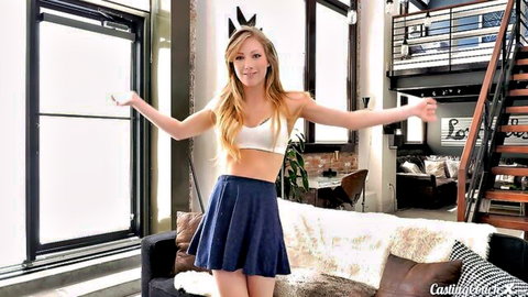 Ivy Wolfe blonde in white bralette and navy mini skirt posing playfully