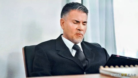 Handsome suited silver fox daddy sits intensely in office chair Brazzers