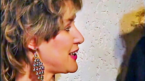 Blonde cougar smiles seductively with glossy red lips in profile closeup
