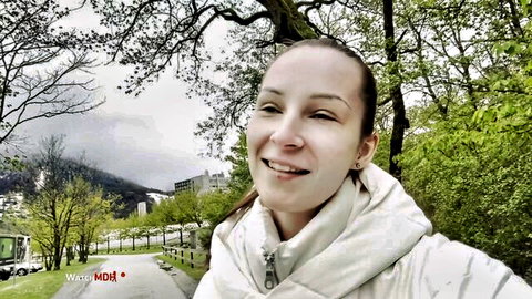 Lu Lu smiling outdoors in European park, teasing big tits