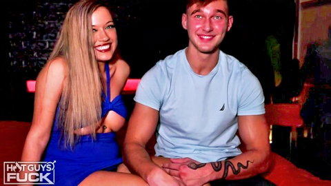 Blonde big-titted babe in sexy blue dress with Brent Savage in steamy club pose