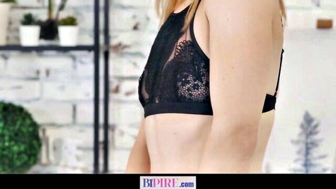 Blonde in sheer black lace bralette posing sideways teasing sideboob and curves
