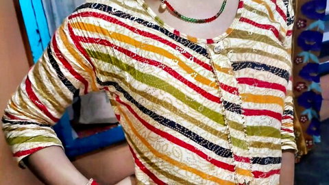 Sexy Indian wife in colorful striped blouse and green necklace showing cleavage