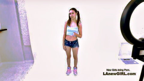 Petite Nicole Auclair in crop top and denim shorts, pigtails pose