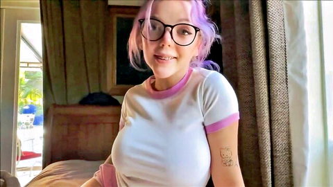 Pink-haired teen with glasses smiles in tight white shirt revealing big natural tits cleavage