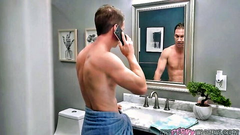 Muscular shirtless DILF stepdad in towel talks on phone in bathroom mirror