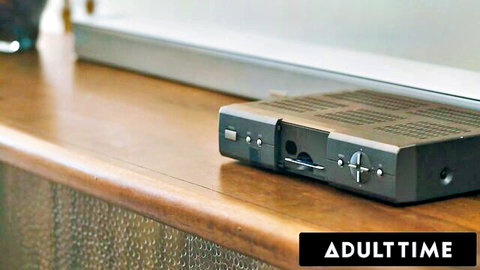 Adulttime streaming device on wooden table ready for porn viewing