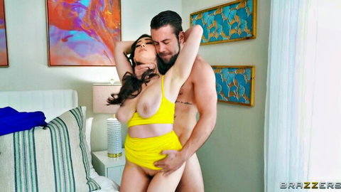 Lily Lou topless in yellow lingerie, embraced by muscular man in steamy Brazzers scene