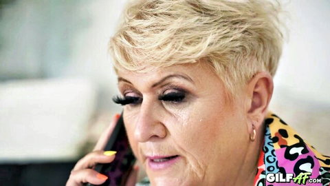 Mature blonde Juicy Jools on phone in leopard top, GILF tease