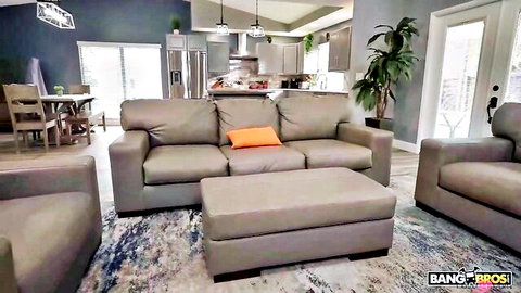 Empty modern living room with gray sofas, orange pillow, kitchen background and BangBros watermark