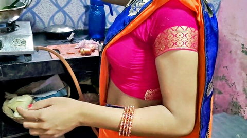 Sexy Indian aunty in tight pink blouse and orange saree