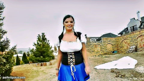 Busty brunette MILF in Bavarian dirndl showing massive tits cleavage outdoors