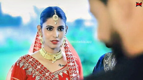 Gorgeous Indian bride in red saree, sultry honeymoon gaze with groom