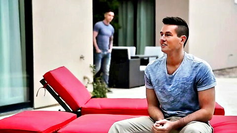 Ryan Pitt lounging poolside with fit stud in casual attire