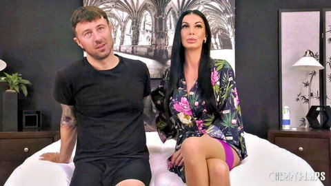 Nikita Reznikova in open floral robe with partner on bed