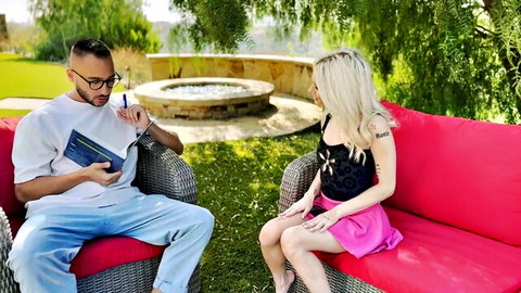 Emma Rosie barefoot in black top and pink skirt chatting outdoors
