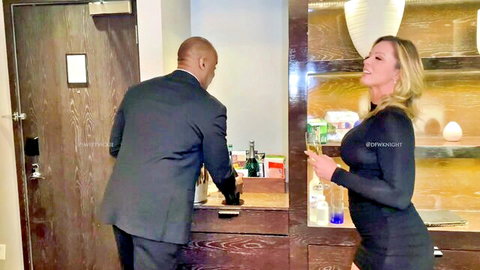 Curvy blonde MILF in tight black dress flirts with suited black stud at hotel bar