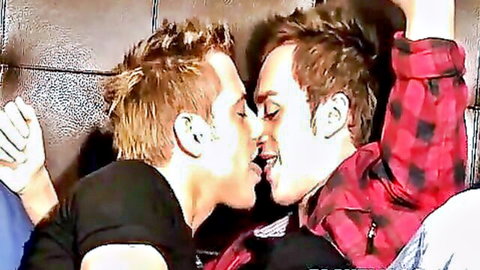 Two red-haired men passionately kissing in intimate embrace