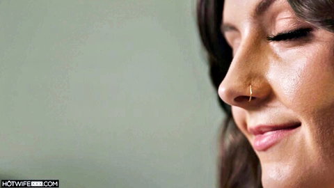 Closeup of sexy tanned brunette smiling with gold nose ring and full lips