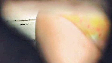 Hot brunette in yellow bikini pissing voyeur style in toilet room