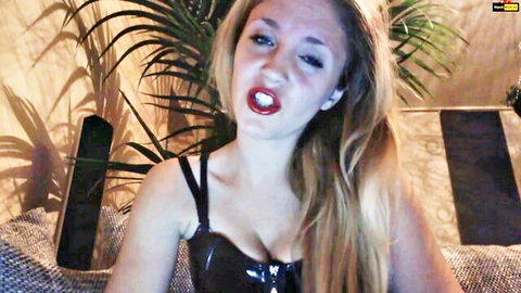 YourGoddess01 in sexy black latex corset, blonde seductress pouting intensely