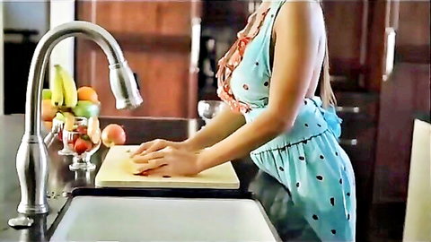 Busty wife in polka dot dress chopping fruits in kitchen tease
