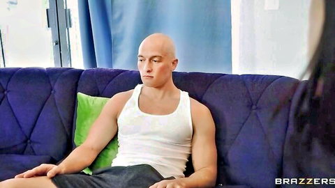 Zac Wild sits on couch as Azul Hermosa approaches in seductive Brazzers scene
