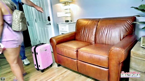 Hot babe in skimpy pink dress teases her round ass with pink suitcase as guy points in hotel room