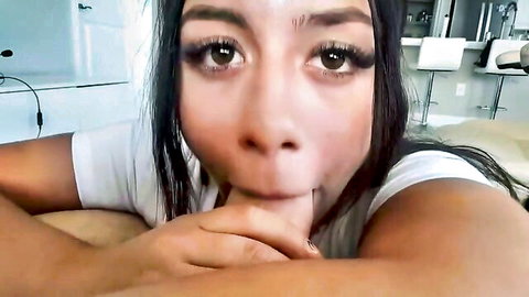 Seductive mixed-race woman with long dark hair pouting in white tank top