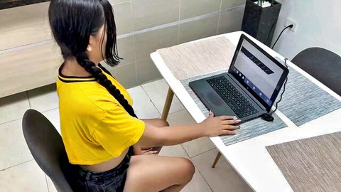 Maira Medina in yellow crop top and shorts at laptop, big tits visible