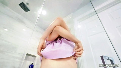 Skinny blonde teen pulls up pink tank top exposing small perky tits in shower