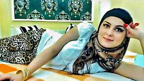 Curvy hijab babe teases with deep cleavage and leopard pants lying seductively on bed