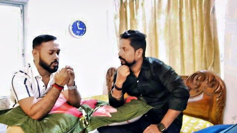 Two Desi men in shirts chatting intimately on bed in step sibling threesome preview